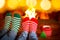 Couple in Christmas socks near fireplace