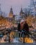 Couple on city trip Amsterdam Netherlands canals with christmas lights during December, canal historical centre of