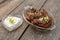 A couple of Classic Buffalo Wings in a glass platter served with ranch dip in a heart shaped bowl