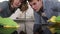 Couple after cleaning cooktop cooking panel on kitchen. Young man and woman check up the perfect clean surface of black