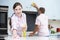 Couple Cleaning Kitchen Surfaces And Cupboards Together