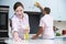 Couple Cleaning Kitchen Surfaces And Cupboards Together