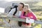 Couple on cliffside outdoors leaning on railing