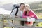 Couple on cliffside outdoors leaning on railing