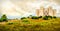 Couple climb steps in a natural yellow landscape to reach Castel del Monte in Apulia - Andria Trani province - Italy