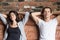 Couple with closed eyes sitting relaxing on couch at home