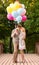 Couple with colorful balloons kissing in the park