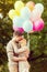 Couple with colorful balloons kissing in the park