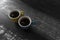 Couple of colorful coffee cups over a black and white table made of wood. A perfect couple concept. Perfect combination.