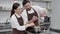 Couple of confectioners, a man and a woman, prepare a mousse in a professional kitchen, pour the yolks from the sugars