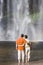 Couple contemplating a waterfall