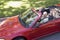 Couple in convertible car smiling