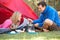 Couple Cooking Breakfast On Camping Holiday