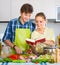 Couple cooking vegetables at kitchen