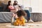 Couple on couch and daughter drawing on floor