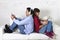 Couple on couch ignoring each other using mobile phone and digital tablet in internet addiction