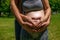 Couple creating a love heart with their hands - pregnancy.