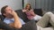 Couple crisis. Man and woman spend the evening in the living room on the couch. the woman uses the phone, the man is