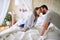 Couple cuddling  in the morning while making the bed. bedroom, morning,  togetherness, romance concept