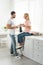 Couple with cups of coffee during breakfast at kitchen