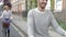 Couple Cycling Along Urban Street Together