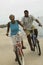 Couple Cycling On Beach