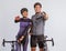 couple in cycling outfit standing with pointed finger beside their bicycle