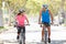 Couple Cycling On Suburban Street