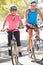 Couple Cycling On Suburban Street