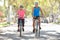 Couple Cycling On Suburban Street