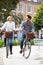 Couple Cycling Through Urban Park Together