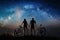 Couple cyclists with mountain bikes at night under starry sky