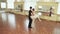 Couple dancing ballet gracefully, male spinning female around