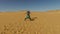 Couple dancing barefoot in desert, Egypt