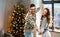 Couple dancing in christmas ugly sweaters at home