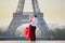 Couple dancing in front of the Eiffel tower in Paris, France