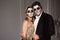 Couple with dark skull makeup on white background. Halloween