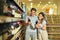 Couple deciding what wine to buy in grocery store