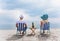 Couple on a deck chair relaxing on the beach.