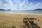 Couple deckchairs on beach at sunset