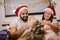 Couple decorates a Christmas tree at home