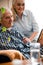 Couple delighting in relatives portrait in frame