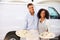 Couple Delivering Pizza Standing In Front Of Van