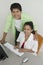 Couple at desk Using Computer portrait high angle view