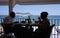 Couple dining in foreground with cruise ship in background at Amalfi, a town in the province of Salerno, in the region of