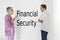 Couple discussing financial security against white wall with English text