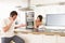 Couple Discussing Personal Finances In Kitchen