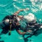 Couple divers plunged into the ocean on a sunny day