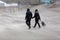 Couple with dog at the beach during strong storm