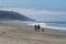 Couple with dog exploring empty California beach